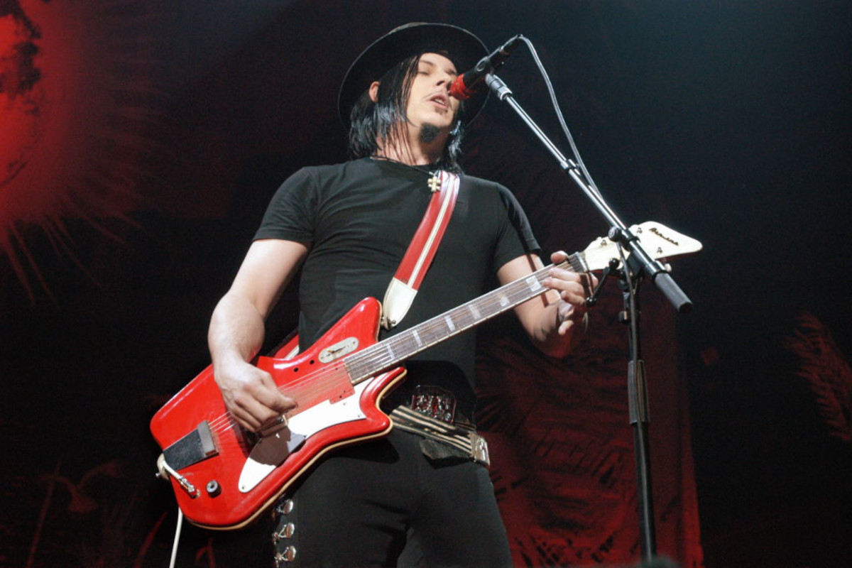 Jack White performing on stage, playing National Airline guitar, 2005