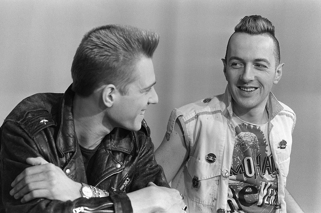 Paul Simonon (L) and Joe Strummer of The Clash during a TV interview in Paris, 198