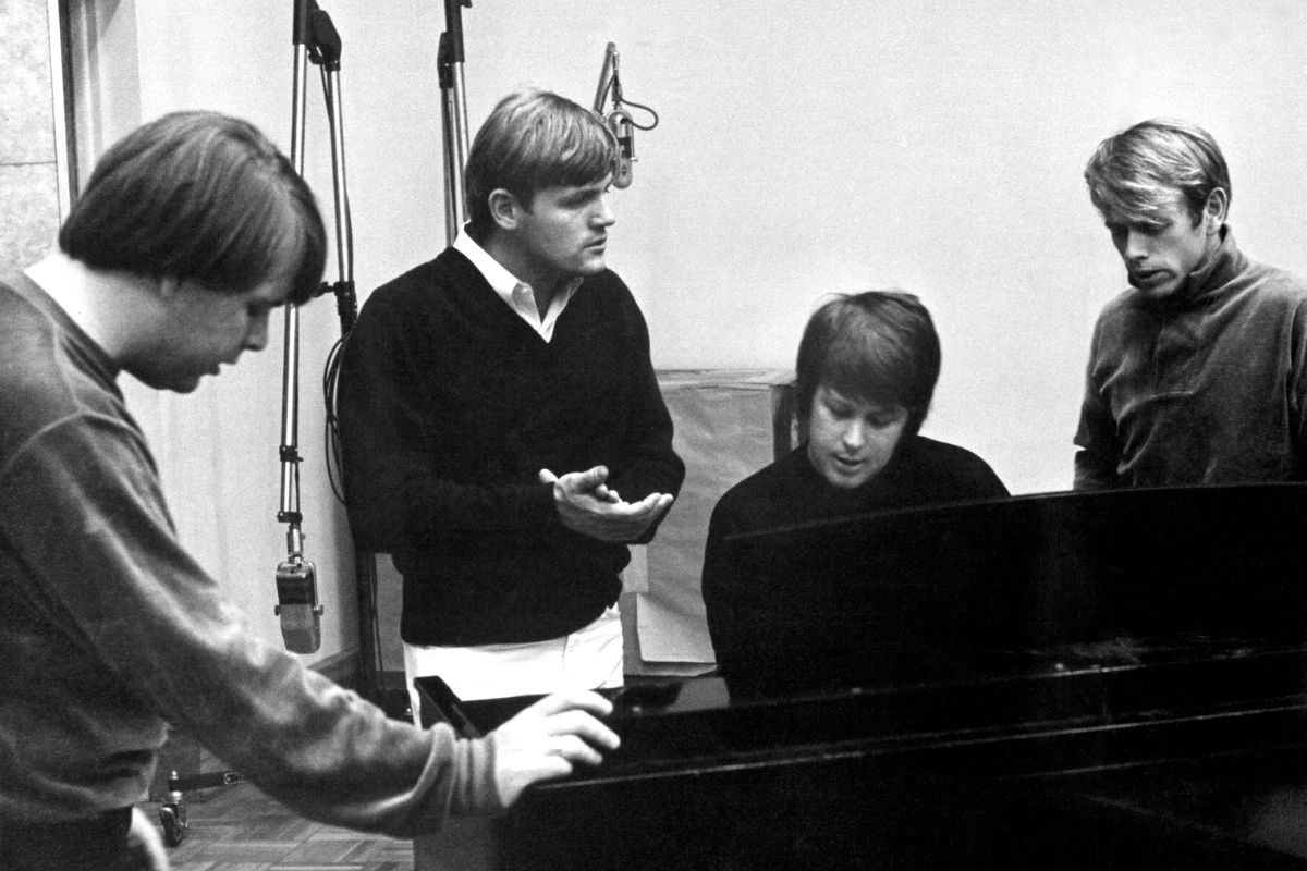 Beach Boys Carl Wilson, Bruce Johnston, Brian Wilson and Al Jardine sing around a piano in the recording studio, 1966
