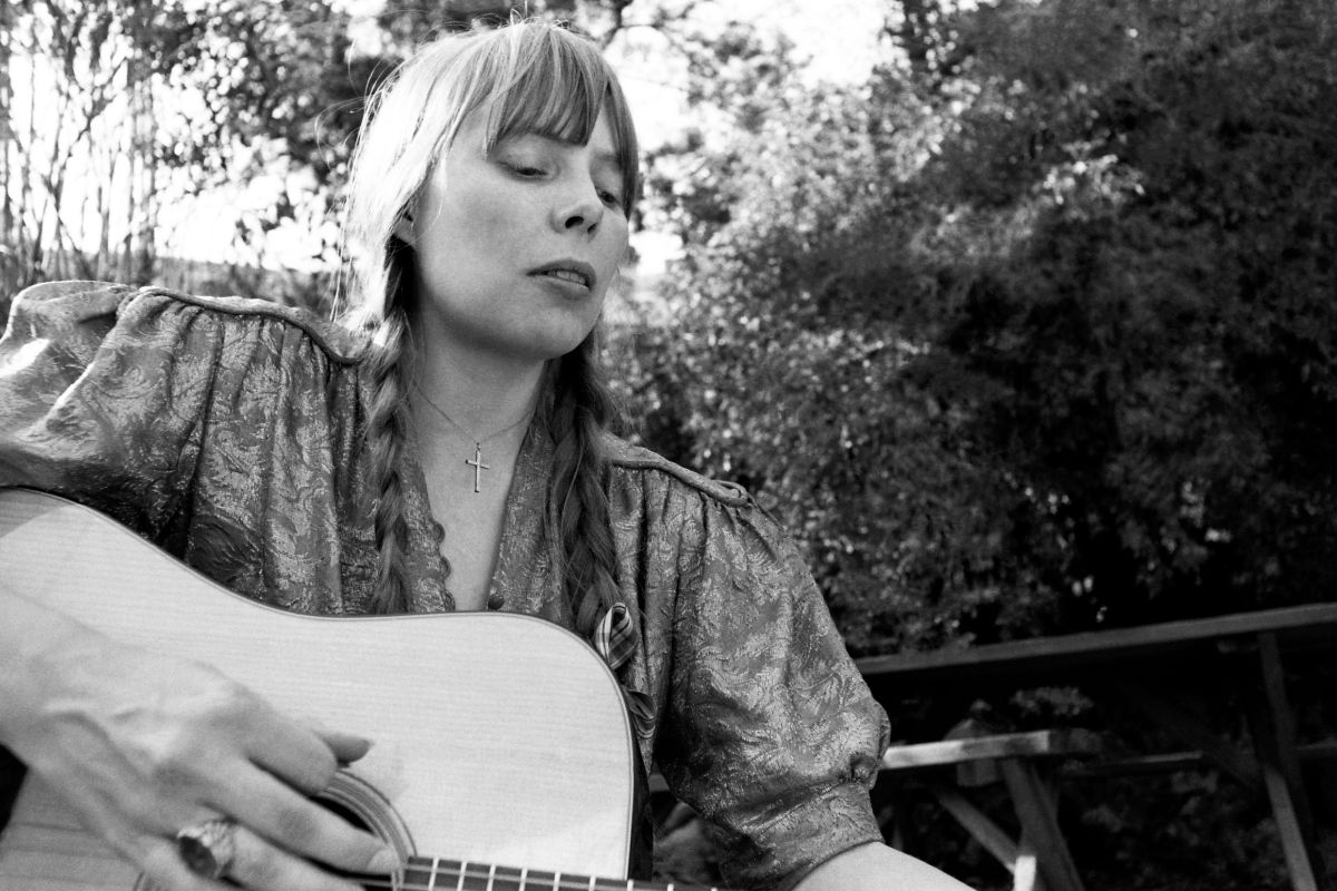 Canadian singer-songwriter Joni Mitchell plays her guitar at her home circa 1970 in Los Angeles, California