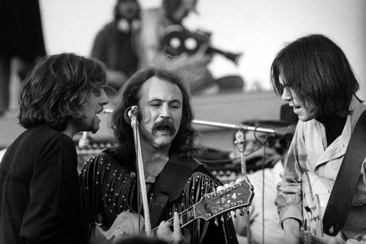 Graham Nash, David Crosby and Neil Young of Cosby Stills Nash and Young perform onstage at The Altamont Speedway on December 6, 1969 in Livermore, California