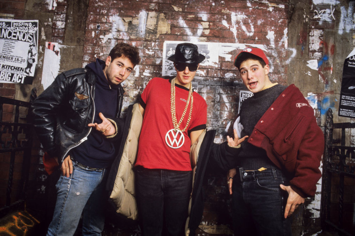 Beastie Boys posing in front of a mural (by Keith Haring), 1987. From left, Mike D, MCA, and Ad-Rock