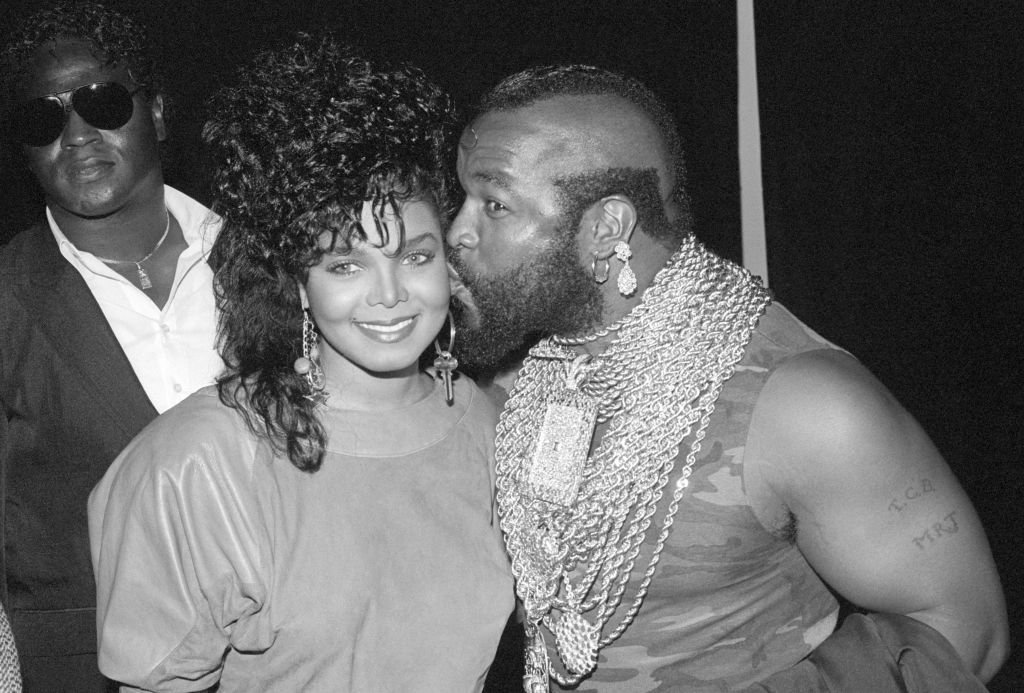 American singer, songwriter, actress, and dancer Janet Jackson is kissed by American actor, television personality, and retired bouncer, bodyguard and professional wrestler Mr. T, during the celebration for 2,000,000 copies sold of the album "Control" circa 1986 in Los Angeles, California