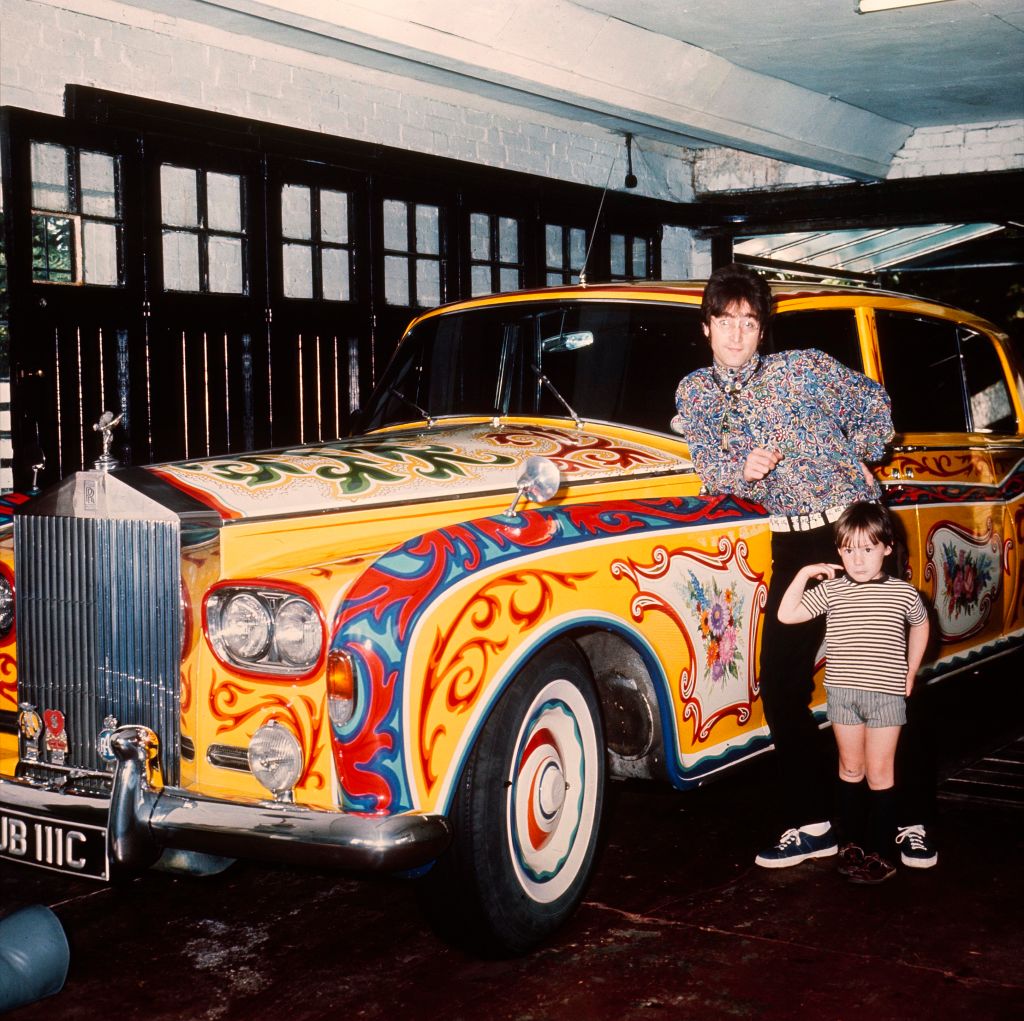 John Lennon at home in Liverpool with his son Julian and his psychedelic Rolls, 1968
