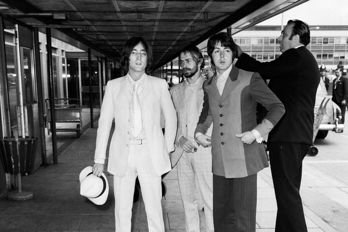 Beatles associate Alexis Mardas (aka 'Magic Alex'), between John Lennon and Paul McCartney, London Airport, 11 May 1968