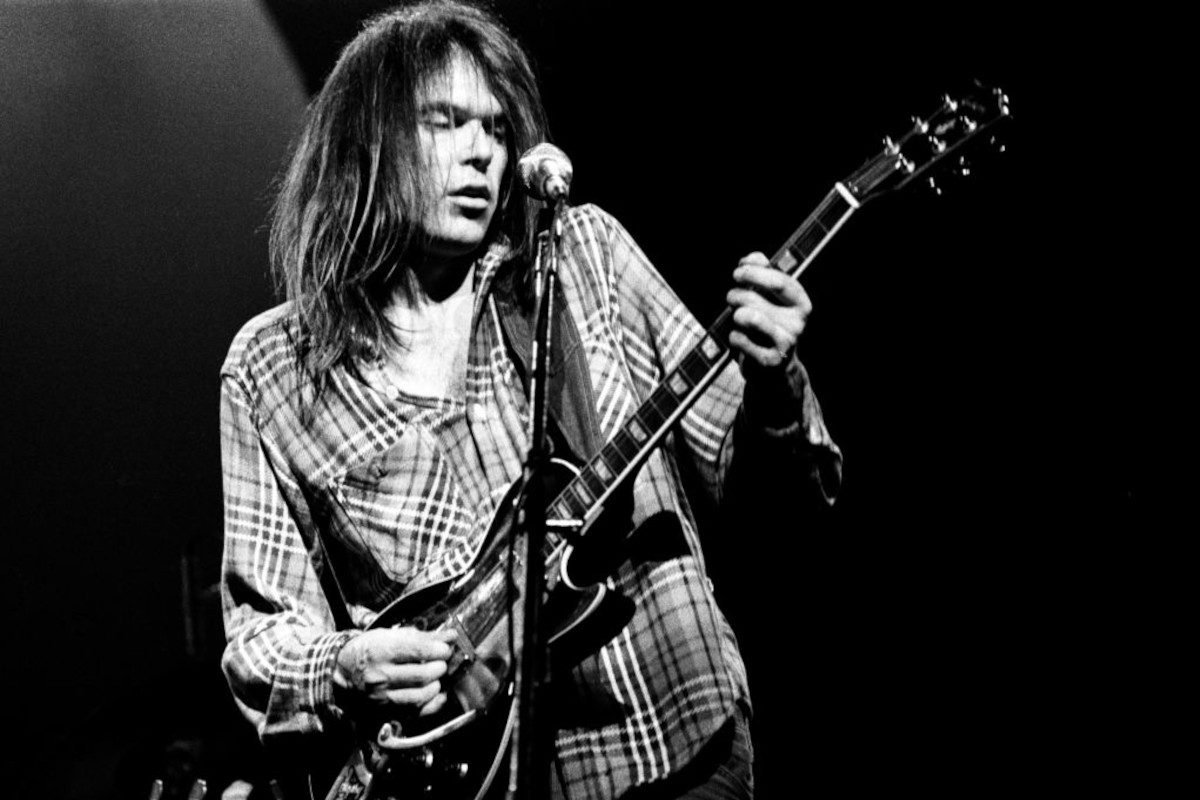 Neil Young performing on stage at Hammersmith Odeon, London, 28th March 1976