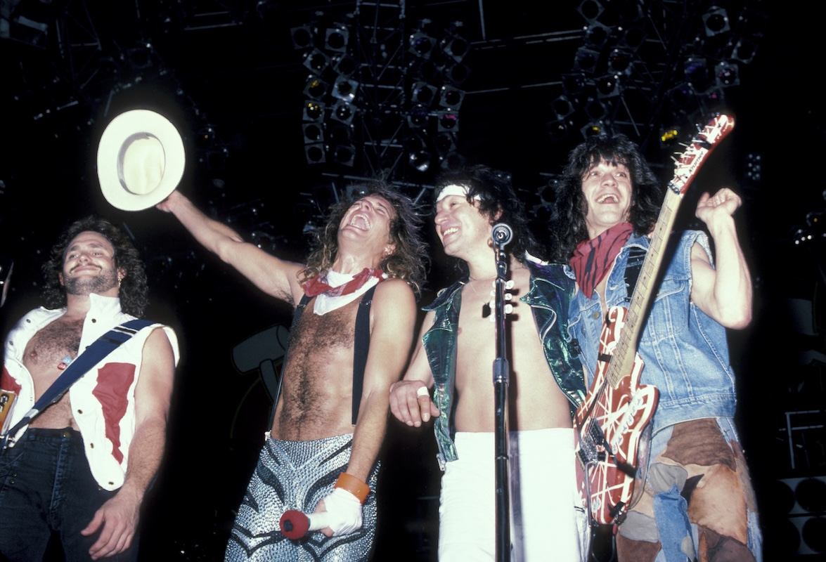 Van Halen on stage for an encore, one member raising hat in air