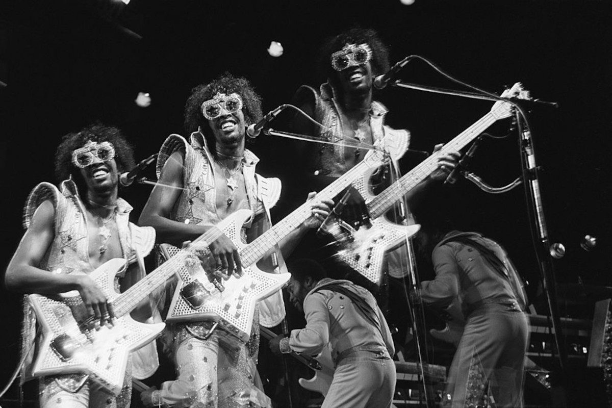 Triple exposure of Bootsy Collins, playing a star-shaped bass guitar during a performance at the Hammersmith Odeon, June 1978