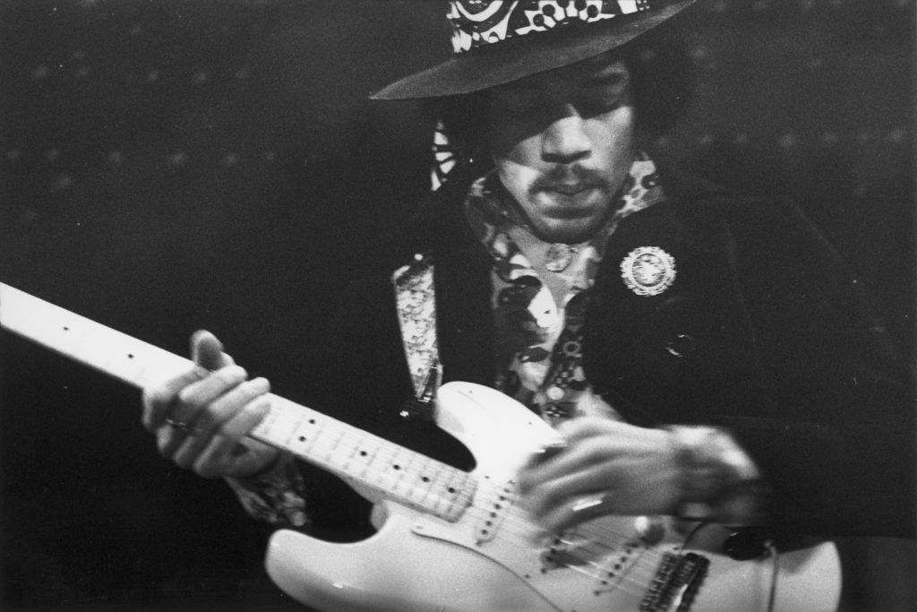 Jimi Hendrix deep in thought while playing his electric guitar, circa 1968
