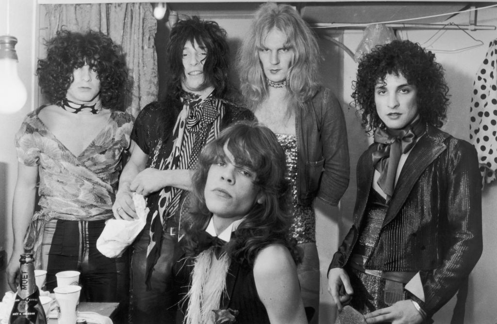 American glam rock band the New York Dolls in their dressing room, 30th October 1972. Standing, left to right: Jerry Nolan, Johnny Thunders, Arthur Kane and Sylvain Sylvain. Seated: singer David Johannson