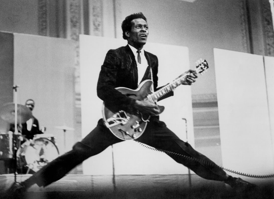 Rock and roll musician Chuck Berry does the splits as he plays his Gibson hollowbody electric guitar in circa 1968
