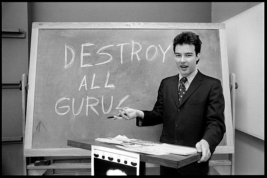 Portrait of American Punk Rock musician Jello Biafra (born Eric Boucher), of the group Dead Kennedys, during his campaign for Mayor of San Francisco, California, September 1979. He stands in front of a chalkboard on which is written, 'Destroy All Gurus.' 