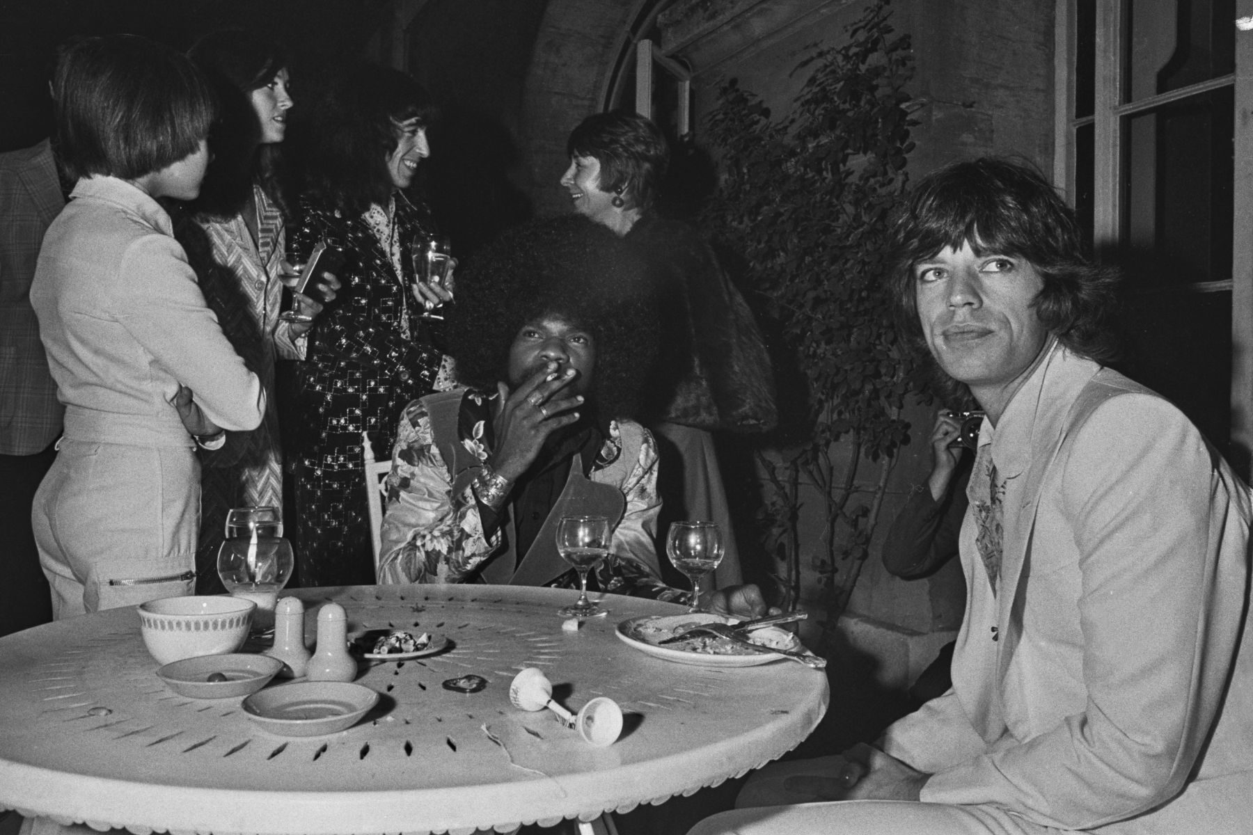 Mick Jagger at a promotional party for the Rolling Stones album Goats Head Soup at Blenheim Palace, Oxfordshire, UK, 6th September 1973. Bassist Bill Wyman is behind