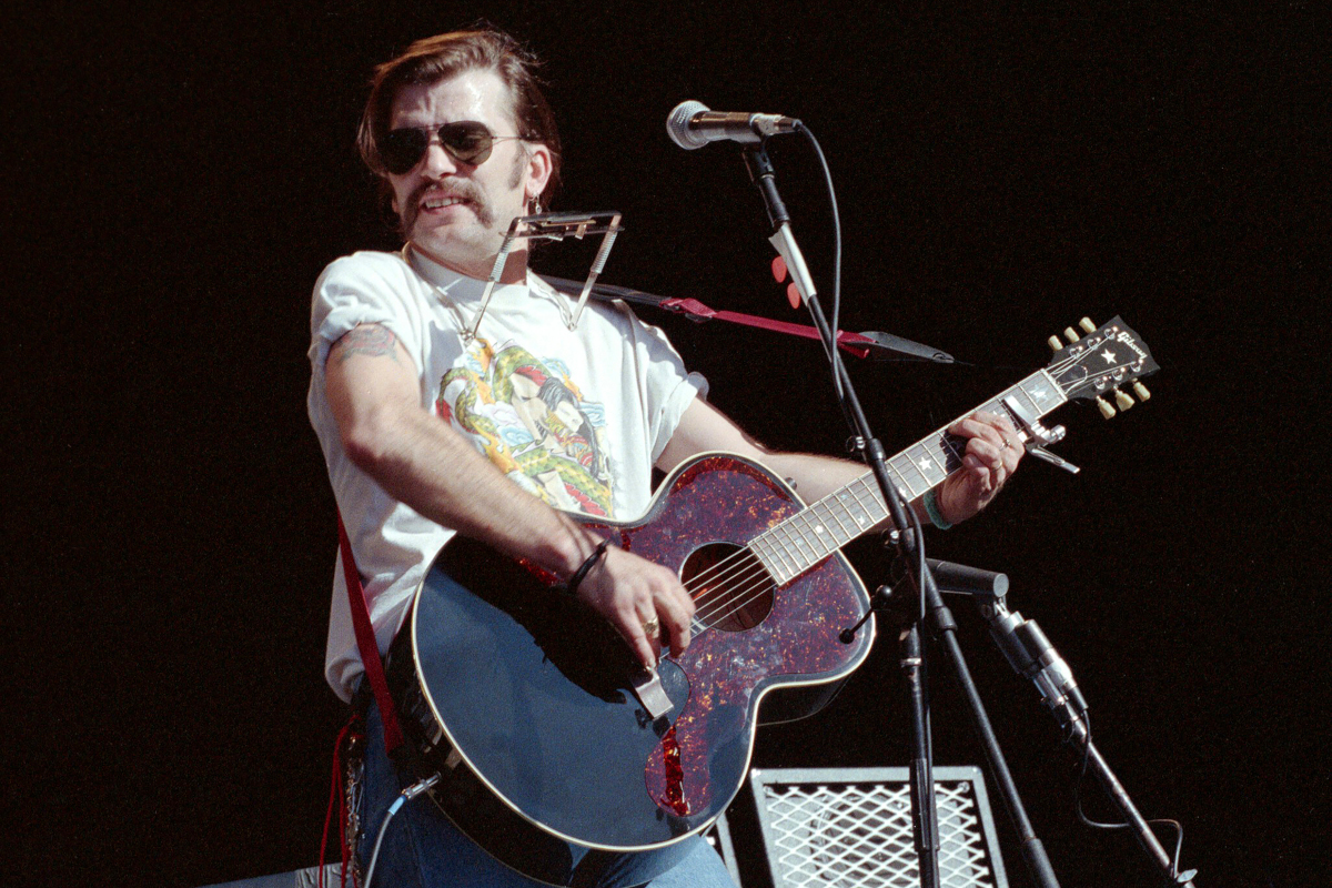 Steve Earle performs during Gathering of the Tribes at Shoreline Amphitheatre on July 7, 1991 in Mountain View, California