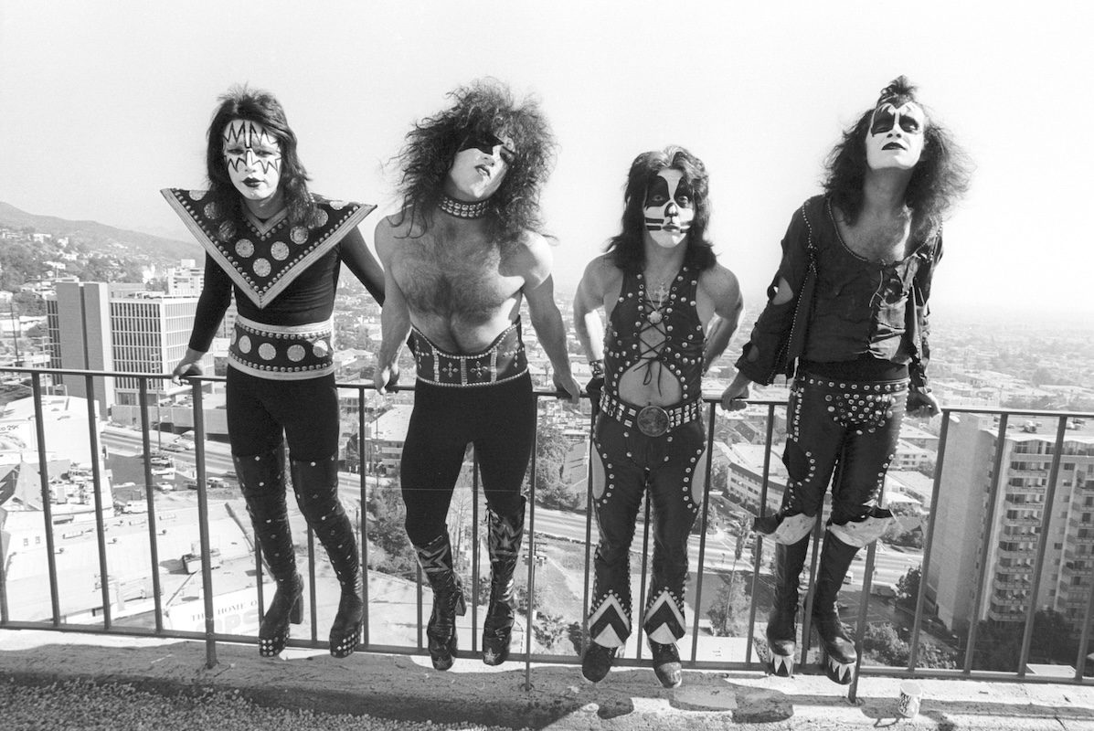 Kiss pose for a portrait session in black and white, wearing full performance dress