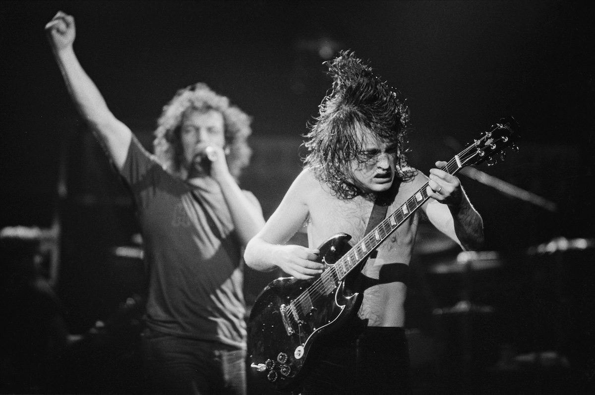Black and white photo of Singer Brian Johnson (left) and guitarist Angus Young performing with Australian hard rock group AC/DC