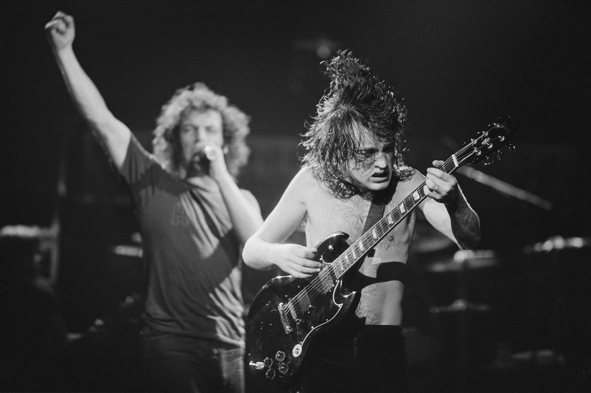 Black and white photo of Singer Brian Johnson (left) and guitarist Angus Young performing with Australian hard rock group AC/DC