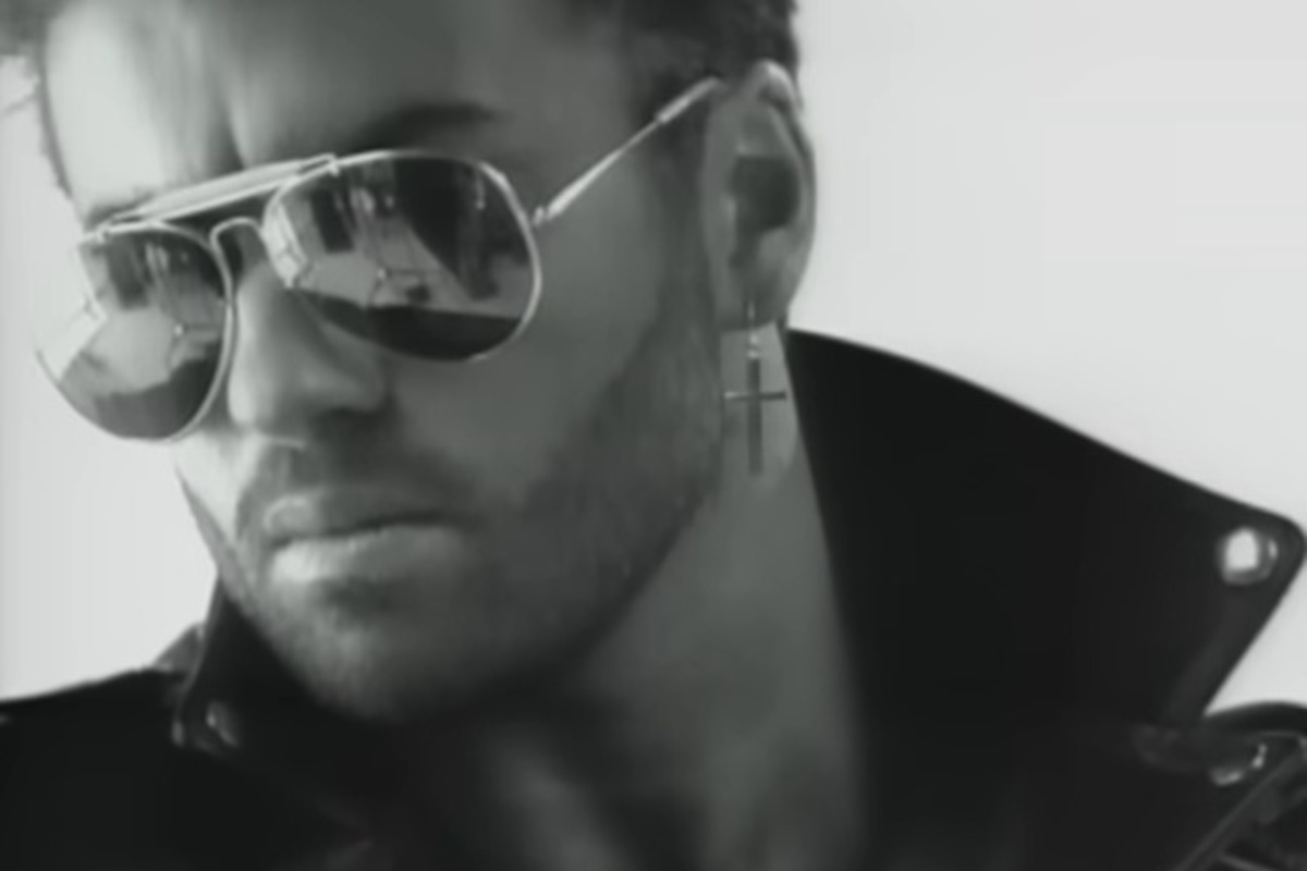 George Michael in Faith, wearing his famous jacket, aviator sunglasses and cross earring