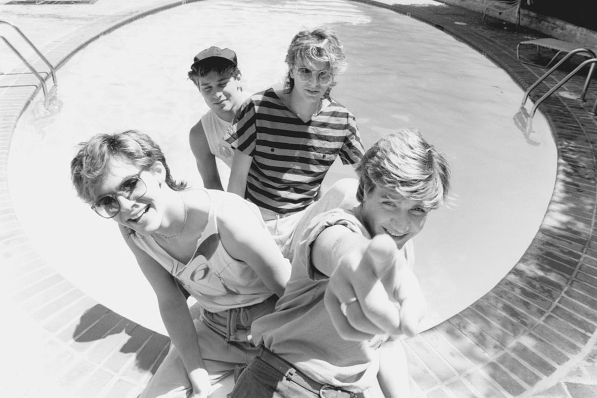 Duran Duran by a swimming pool in Hollywood, 1983. L to R, Nick Rhodes, Roger Taylor, John Taylor, and Simon Le Bon
