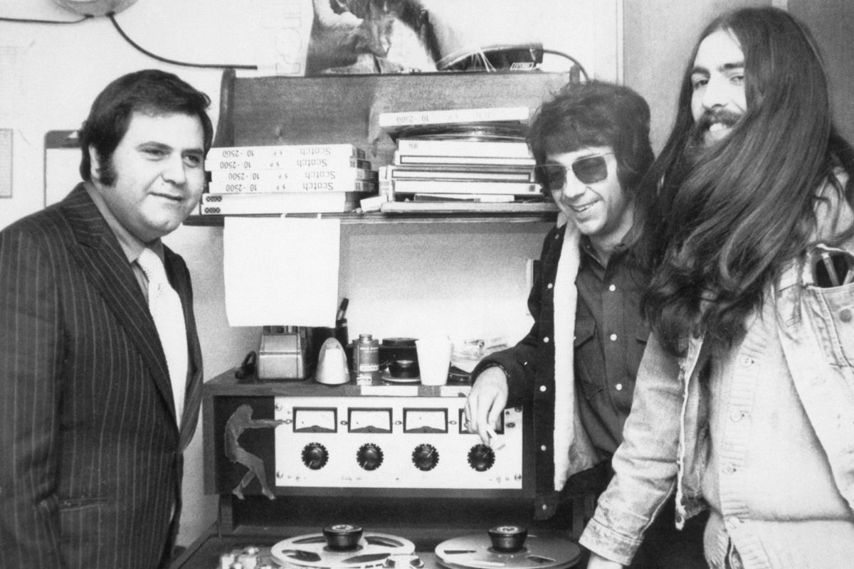 Former Beatle George Harrison (right) listens to master tapes of his first solo album All Things Must Pass in the recording studio with Spector (centre) and Pete Bennett of Apple Records, October 1970