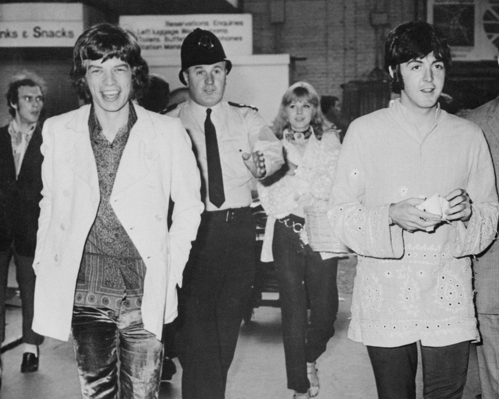 Mick Jagger and Paul McCartney at Euston Sation, London, boarding a train for Bangor to hear the Himalayan mystic Maharishi Mahesh Yogi