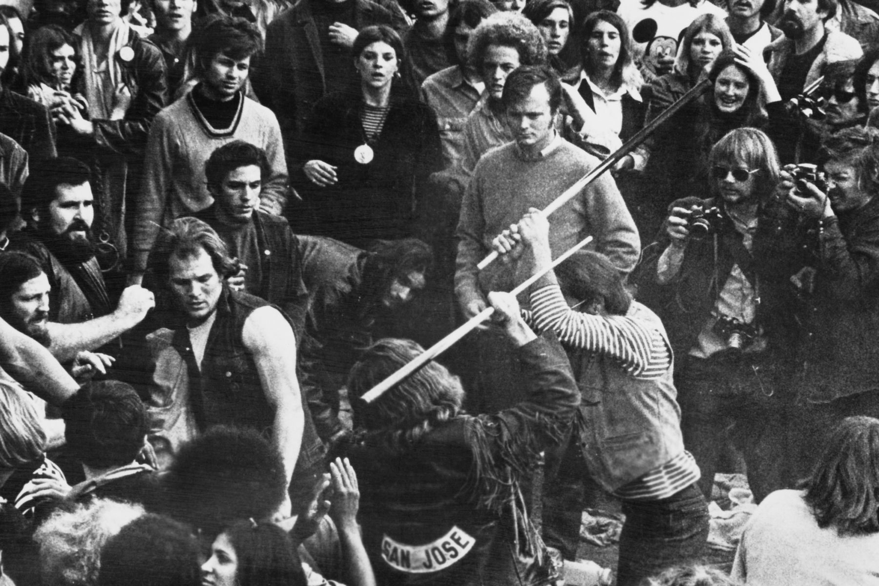 A still from the documentary film 'Gimme Shelter', showing audience members looking on as Hells Angels beat a fan with pool cues at the Altamont Free Concert, Altamont Speedway, California, 6th December 1969