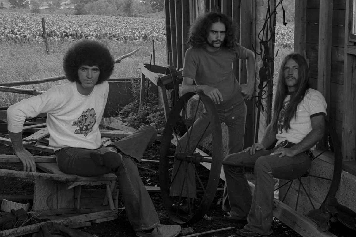 Grand Funk Railroad posing in an unloved barn, circa 1972