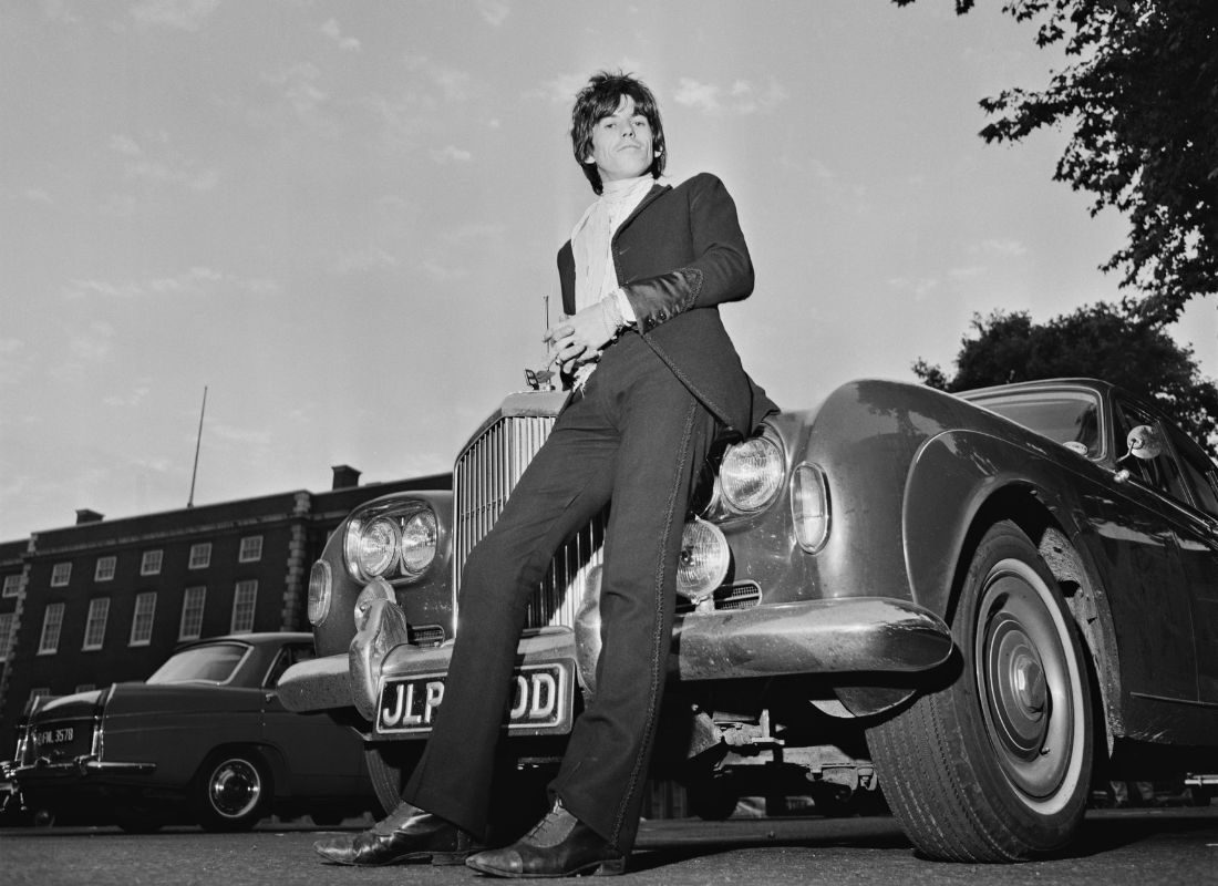 Keith Richards stands guard over his Bentley after being released on bail on drug-related charges, 30 June 1967