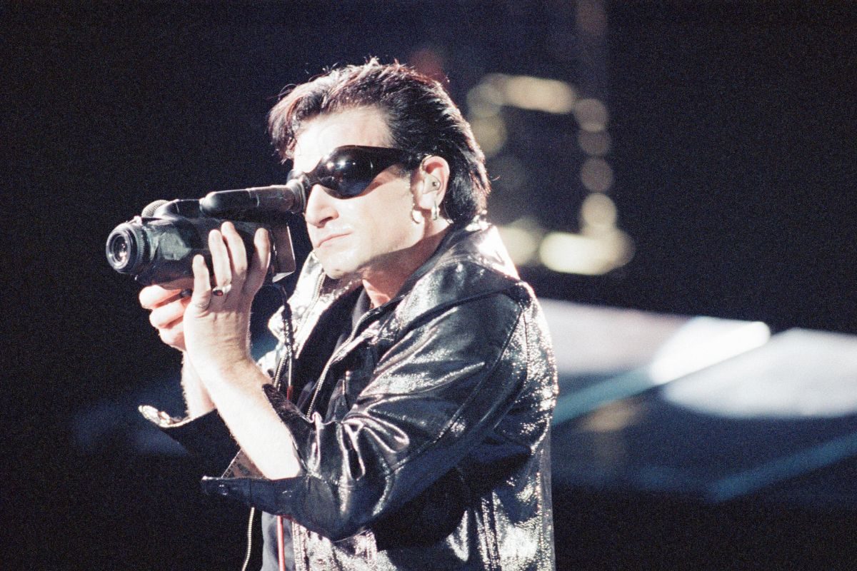 U2 singer Bono onstage with camcorder, Cardiff, Wales, 1993