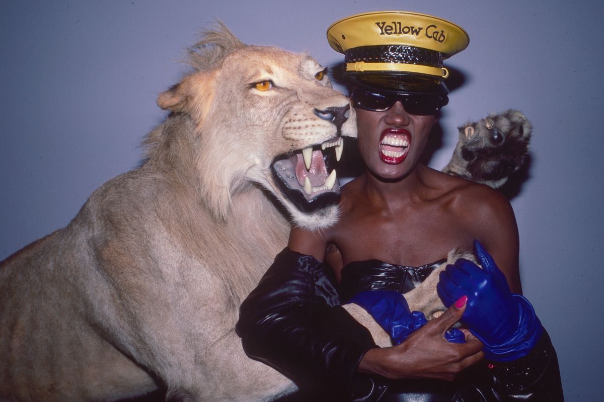 Jamaican-born singer and model Grace Jones poses with a lion at the Area nightclub, New York, New York, March 1, 1984