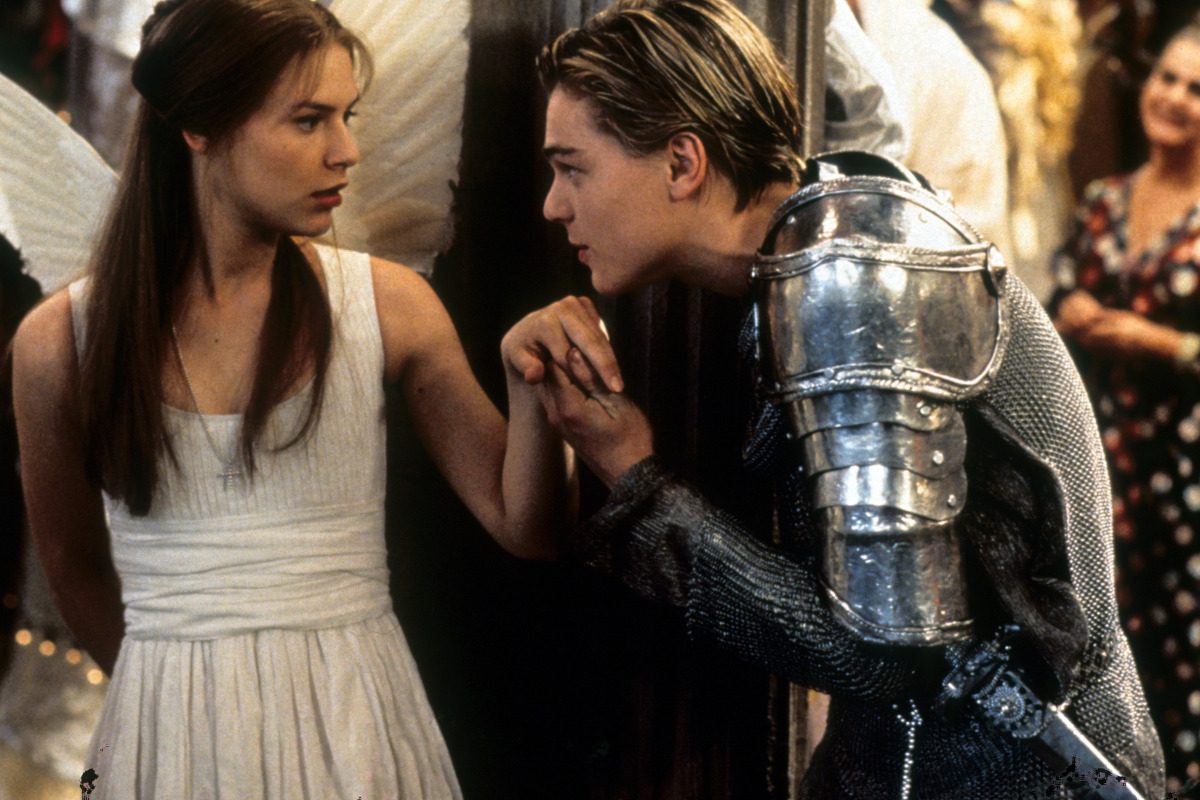 Claire Danes is surprised as Leonardo DiCaprio takes her hand to kiss in scene from the film 'Romeo + Juliet', 1996