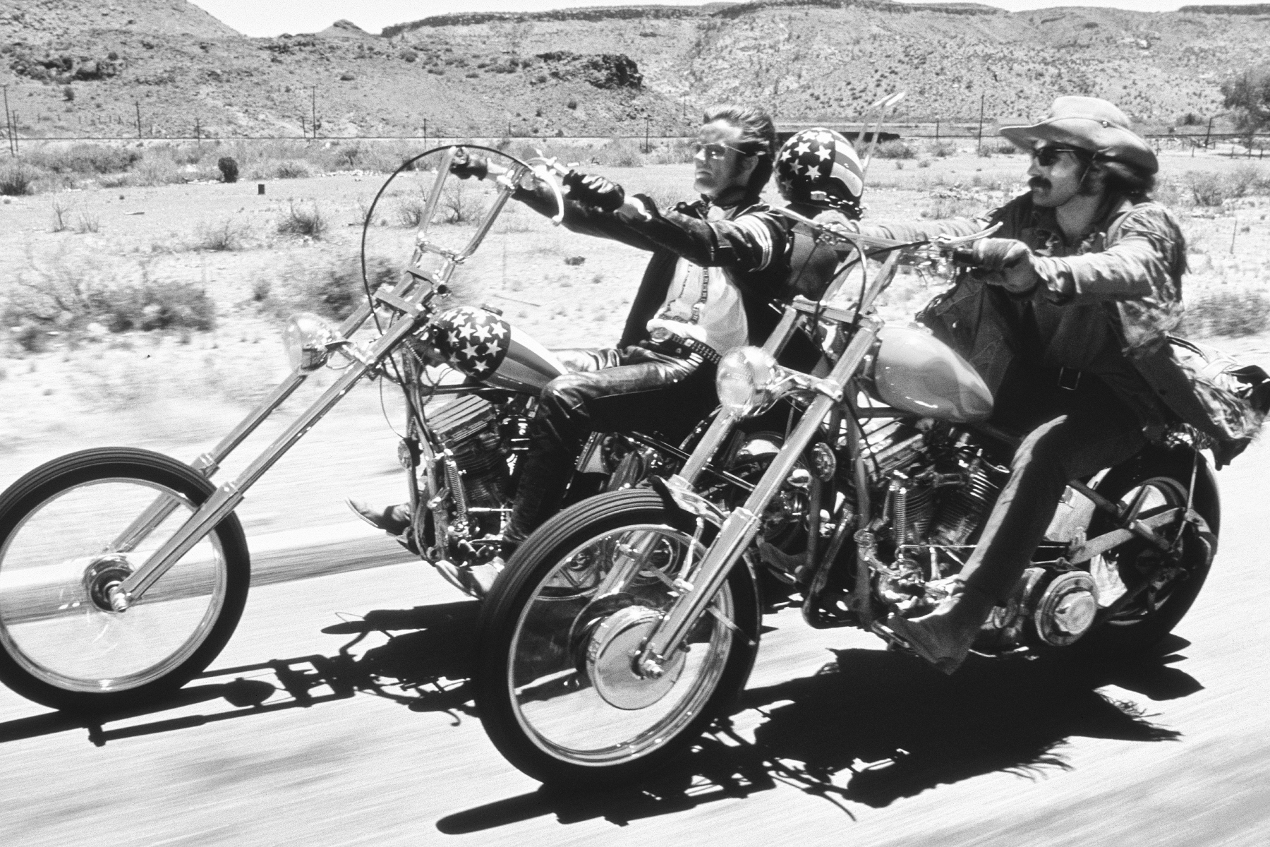American actors Dennis Hopper and Peter Fonda ride through the Desert on motorcycles in a scene from the film 'Easy Rider', directed by Hopper, 1969 (converted to black and white)