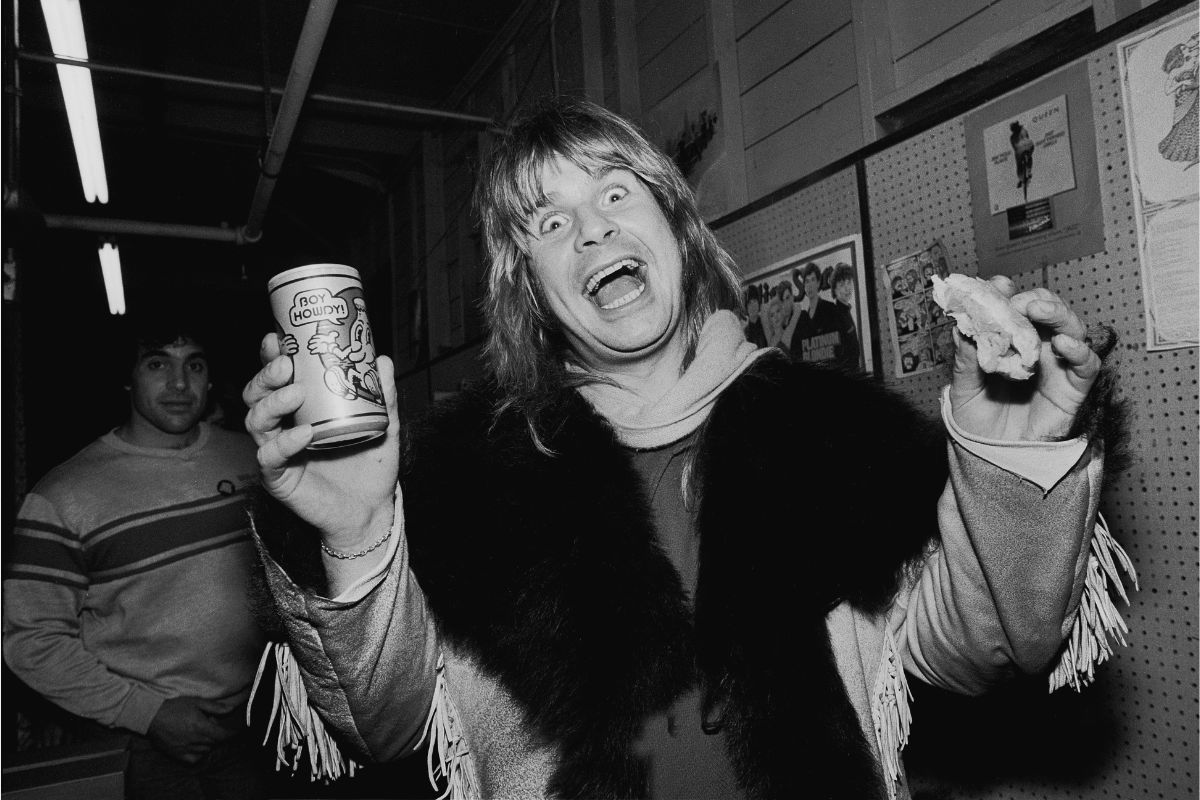 Ozzy Osbourne poses with a sandwich and a Creem Magazine 'Boy Howdy' beer at Rolling Stone Records, 11 December 1981 in Chicago, Illinois