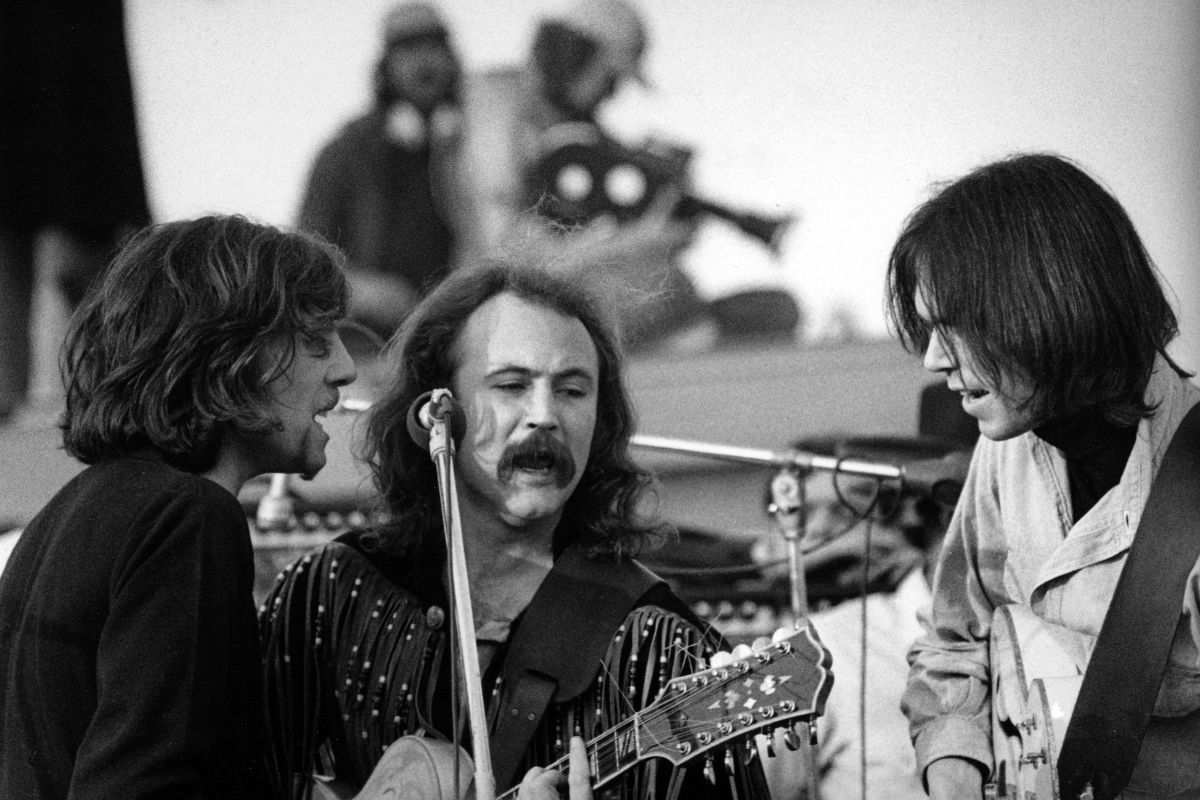 Graham Nash, David Crosby and Neil Young of Crosby Stills Nash and Young perform onstage at The Altamont Speedway on December 6, 1969 in Livermore, California