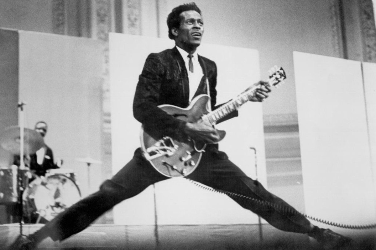 Chuck Berry does the splits as he plays his Gibson hollowbody electric guitar, circa 1968