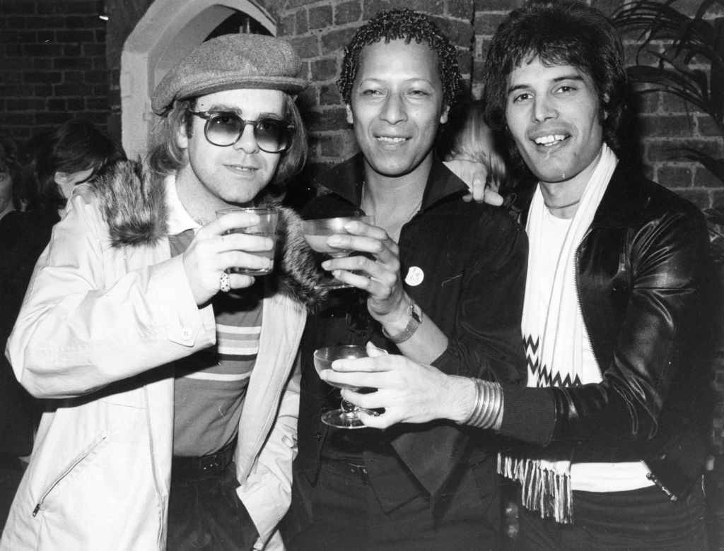 Singer songwriter Elton John (Reginald Dwight) with star of musicals Peter Straker, and Freddie Mercury (Frederick Bulsara, 1946 - 1991), singer with the group Queen.