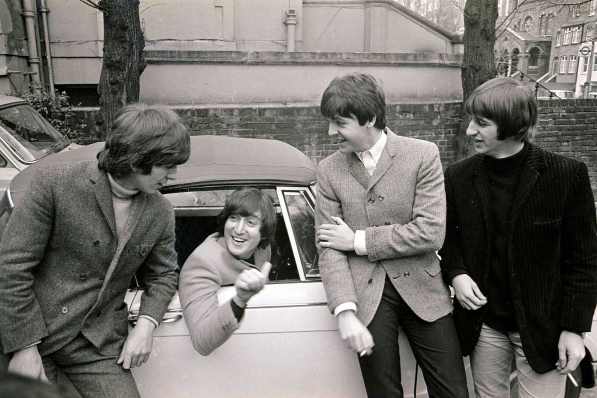 The Beatles 1965. L-R George Harrison, John Lennon (in car), Paul McCartney and Ringo Starr