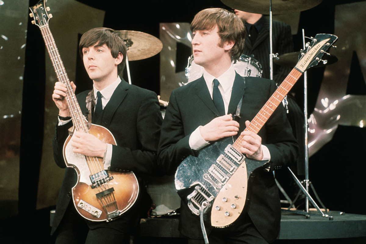 Paul McCartney (left) and John Lennon perform on the set of 'The Ed Sullivan Show', February 8, 1964