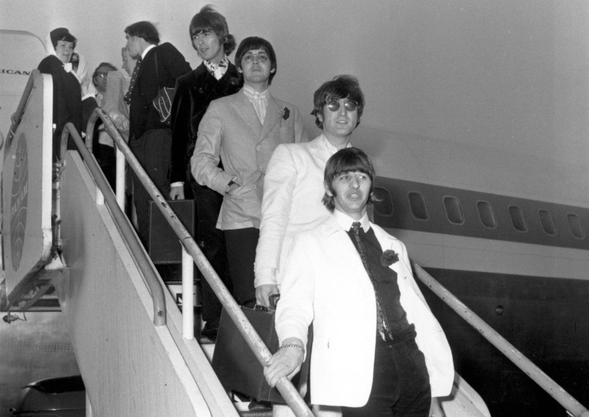 The Beatles disembark from a plane at London Airport, returning from their American tour, 31 August 1966