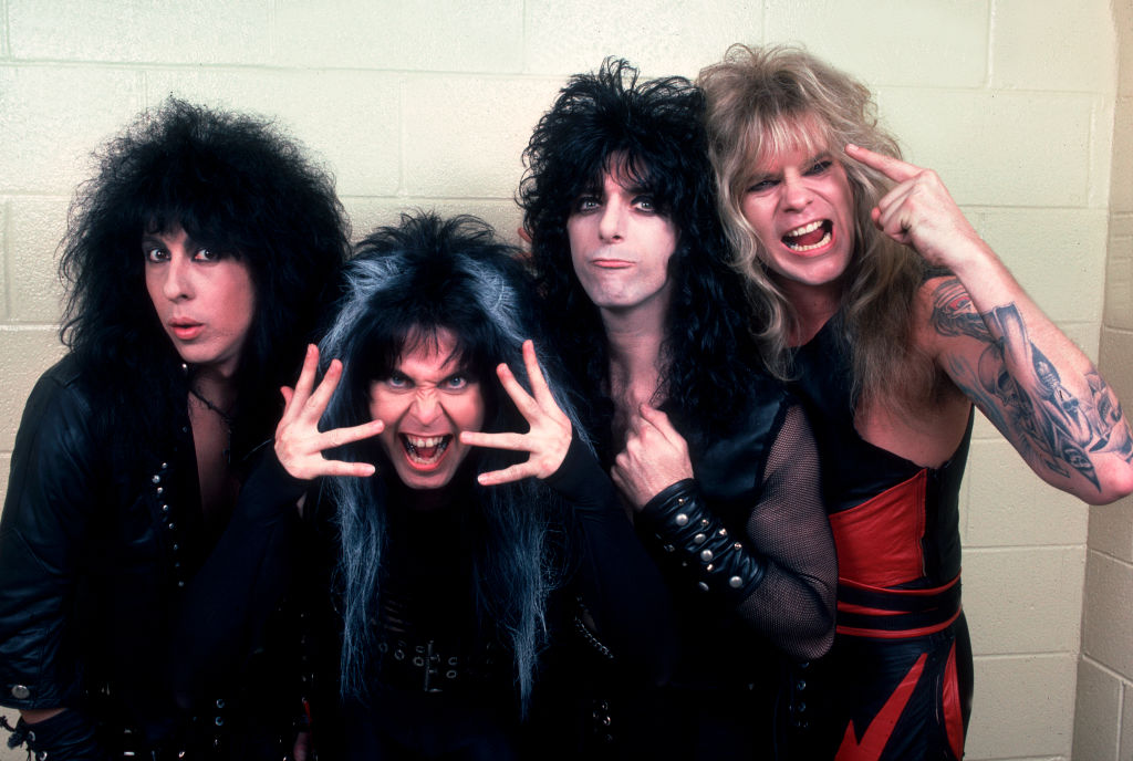 American Heavy Metal group WASP as they pose backstage at the Riviera Theater, Chicago, Illinois, January 19, 1986. Pictured are Tony Richards, Blackie Lawless, Randy Piper, and Chris Holmes