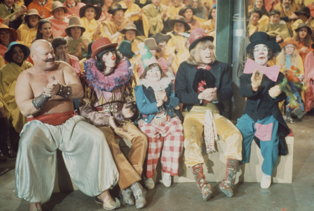 Bill Wyman and Brian Jones with various clowns and entertainers on the set of the Rolling Stones Rock and Roll Circus at Intertel TV Studio in Wembley, London on 11th December 1968