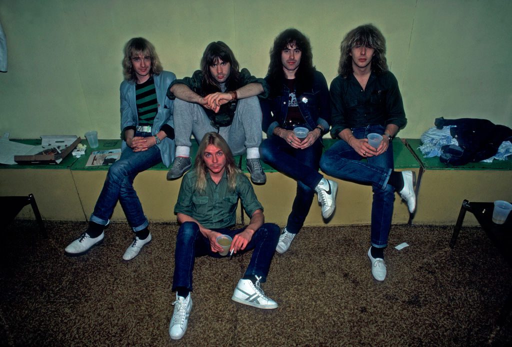 Portrait of British heavy metal band Iron Maiden backstage at the Rosemont Horizon during their Beast on the Road Tour, Chicago, Illinois, September 21, 1982. Pictured are, from left, Adrian Smith, Bruce Dickinson, Dave Murray (on floor), Steve Harris, and Clive Burr