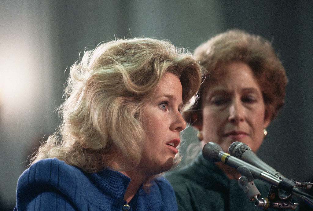 Tipper Gore (left), wife of Tennessee senator Al Gore, testifies before a Senate committee discussing government regulation of objectionable music lyrics, May 1985. Susan Baker, wife of government official James Baker, listens at right