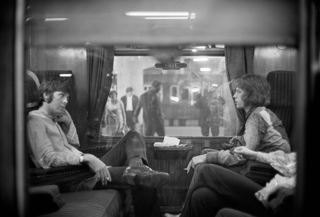 Paul McCartney and Mick Jagger on the train to Bangor, 1967