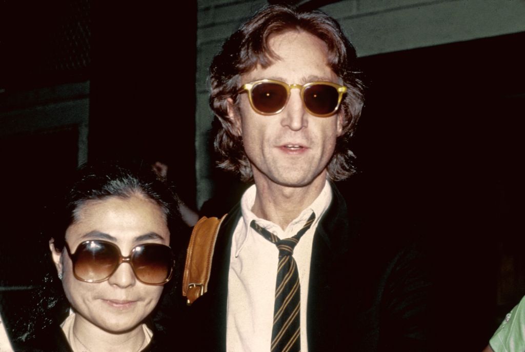 John Lennon and his wife Yoko Ono pose for a portrait outside of the Times Square recording studio 'The Hit Factory' before a recording session of his final album 'Double Fanasy' in August 1980 in New York City