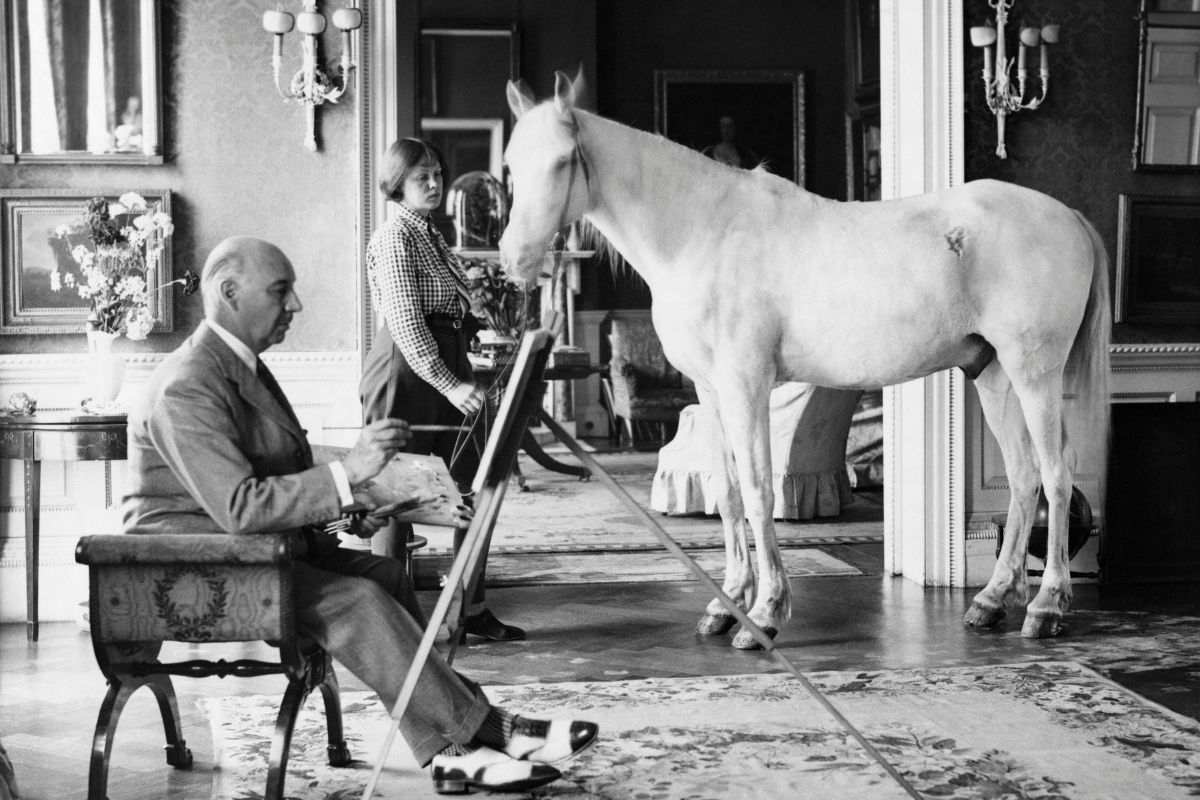 English composer and eccentric Lord Berners painting a picture of Mrs Penelope Betjeman and her Arab pony, at his home in Berkshire, 1938