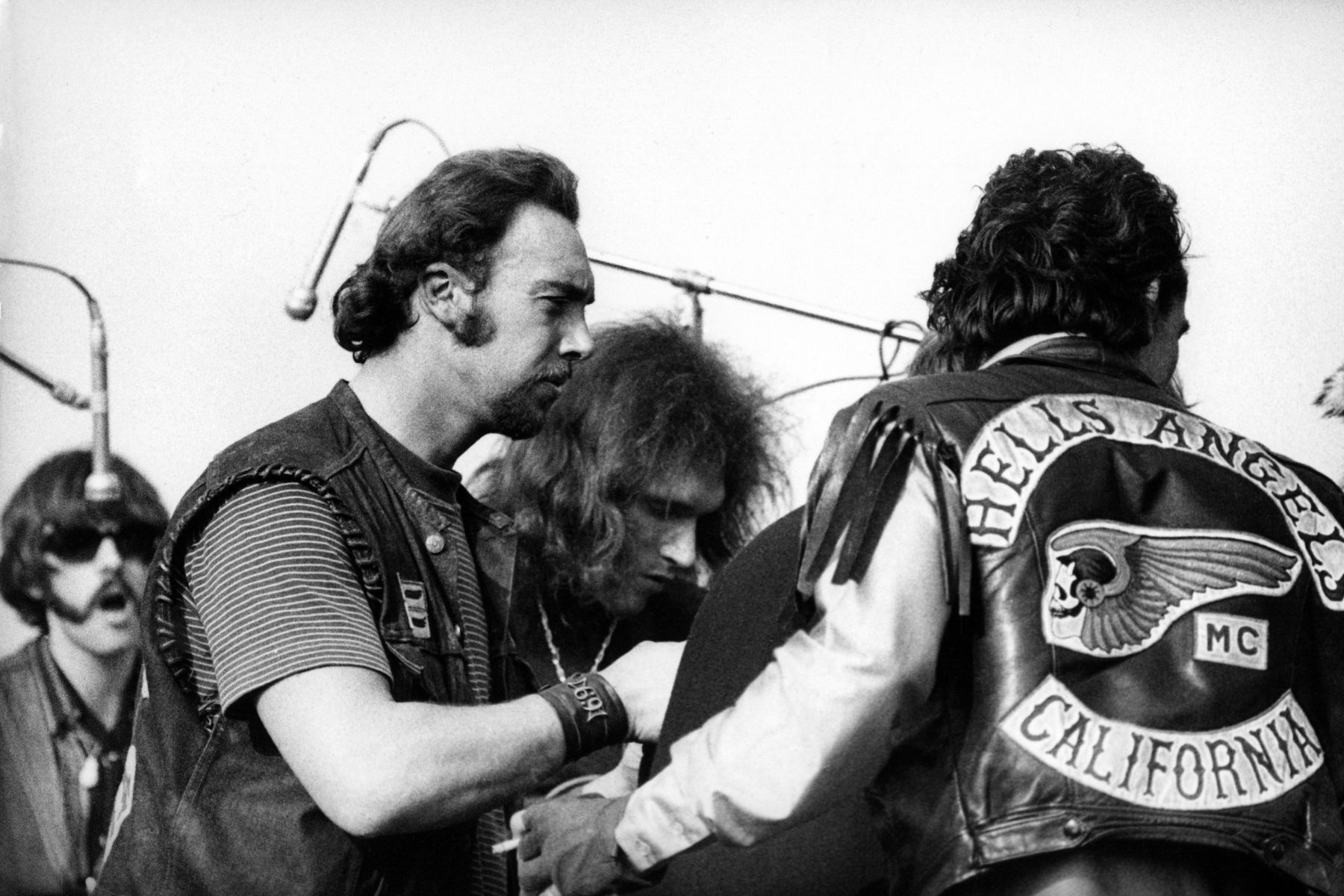 Members of the Hells Angels gang, acting as both security and hoodlums, jump the stage at the Jefferson Airplane concert on December 6, 1969 at the Altamont Speedway, California