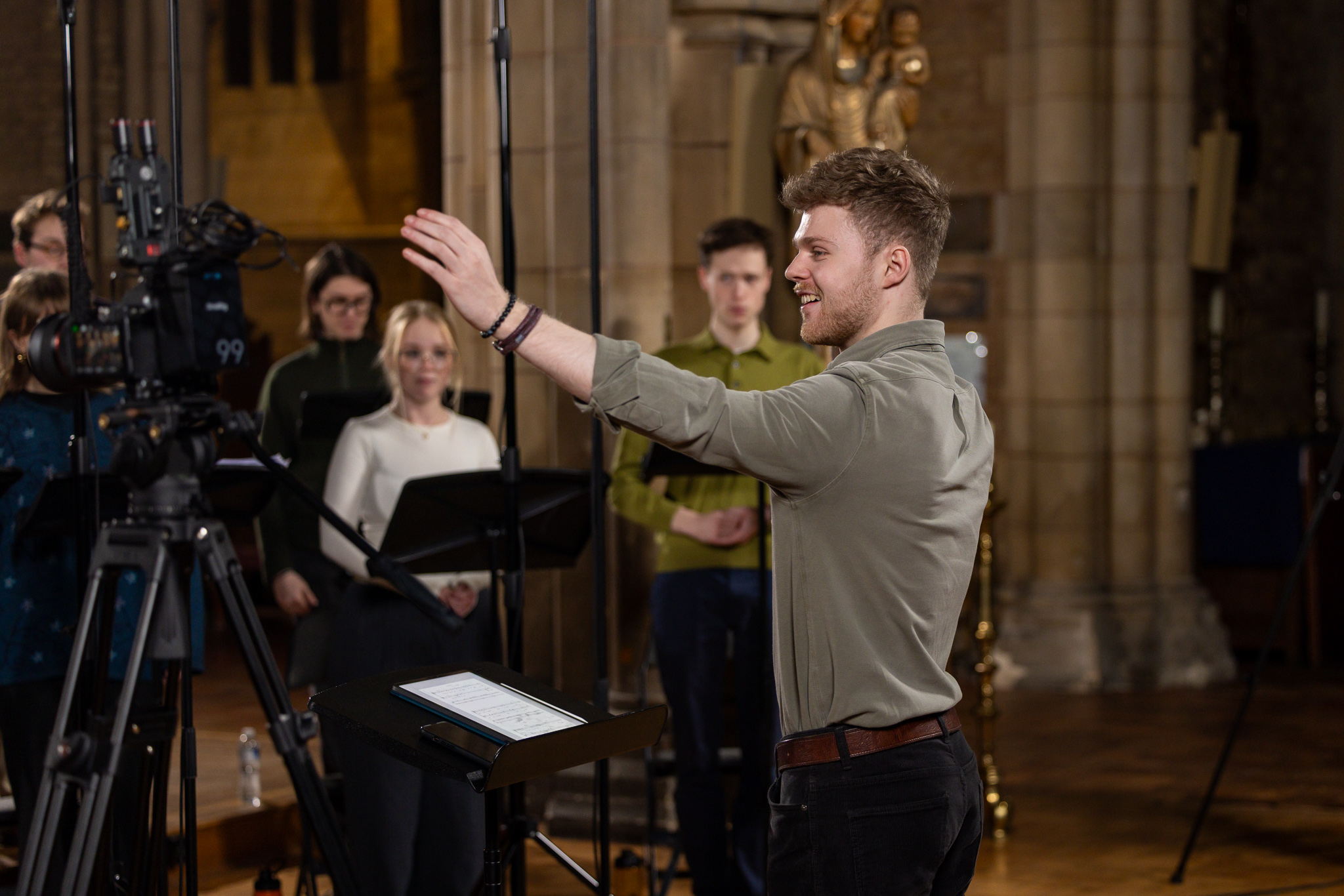 Young man conducts a choir in a church
