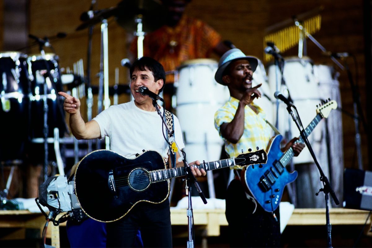 Paul Simon performs on stage during a tour to promote his Graceland album, 1987