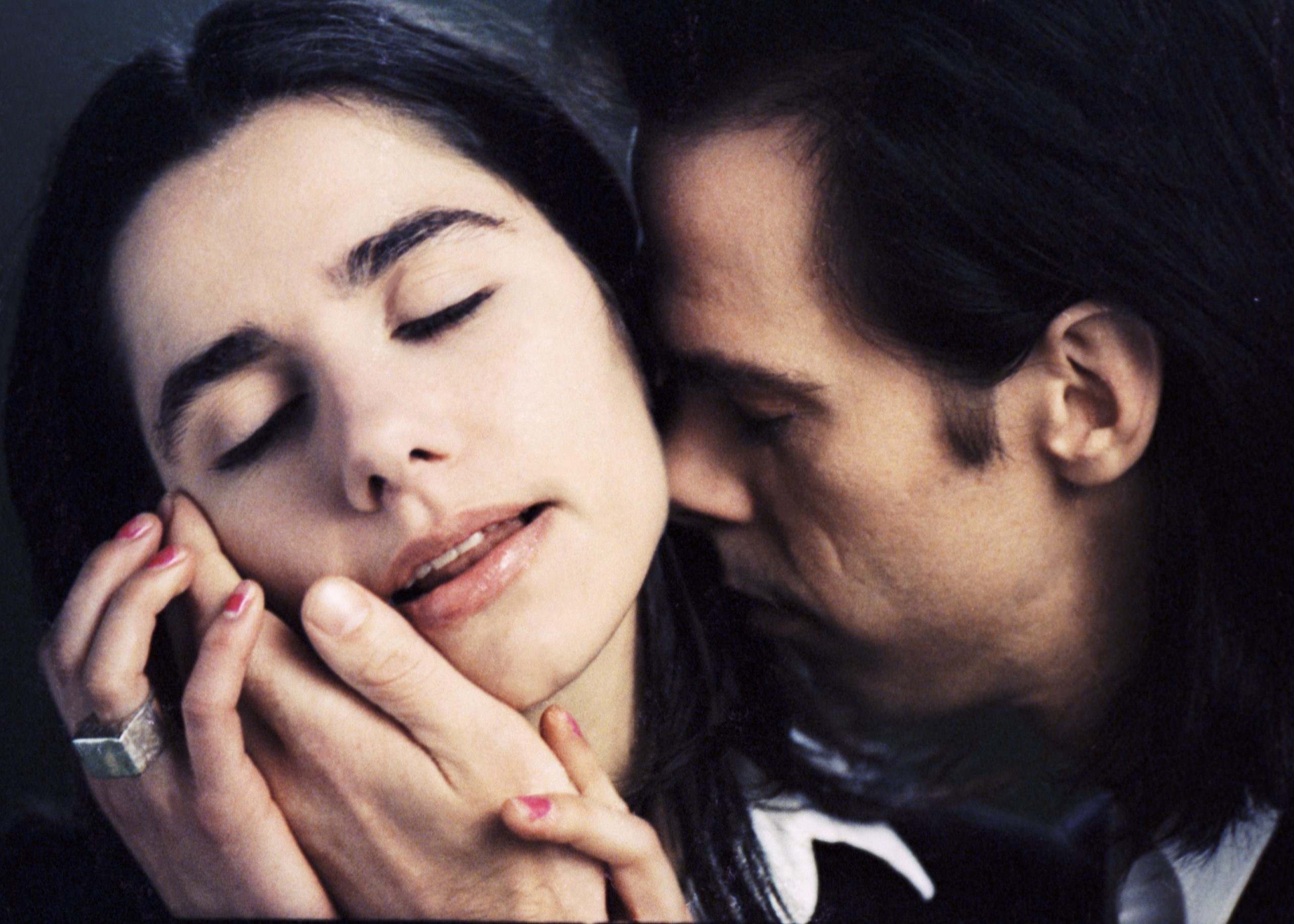 Nick Cave touching PJ Harvey's face up close